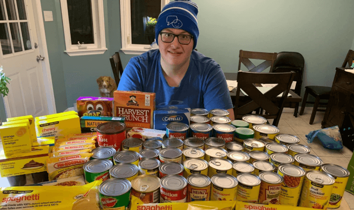 Topsail Venturer with a table of food items for the Little Free Pantry Project