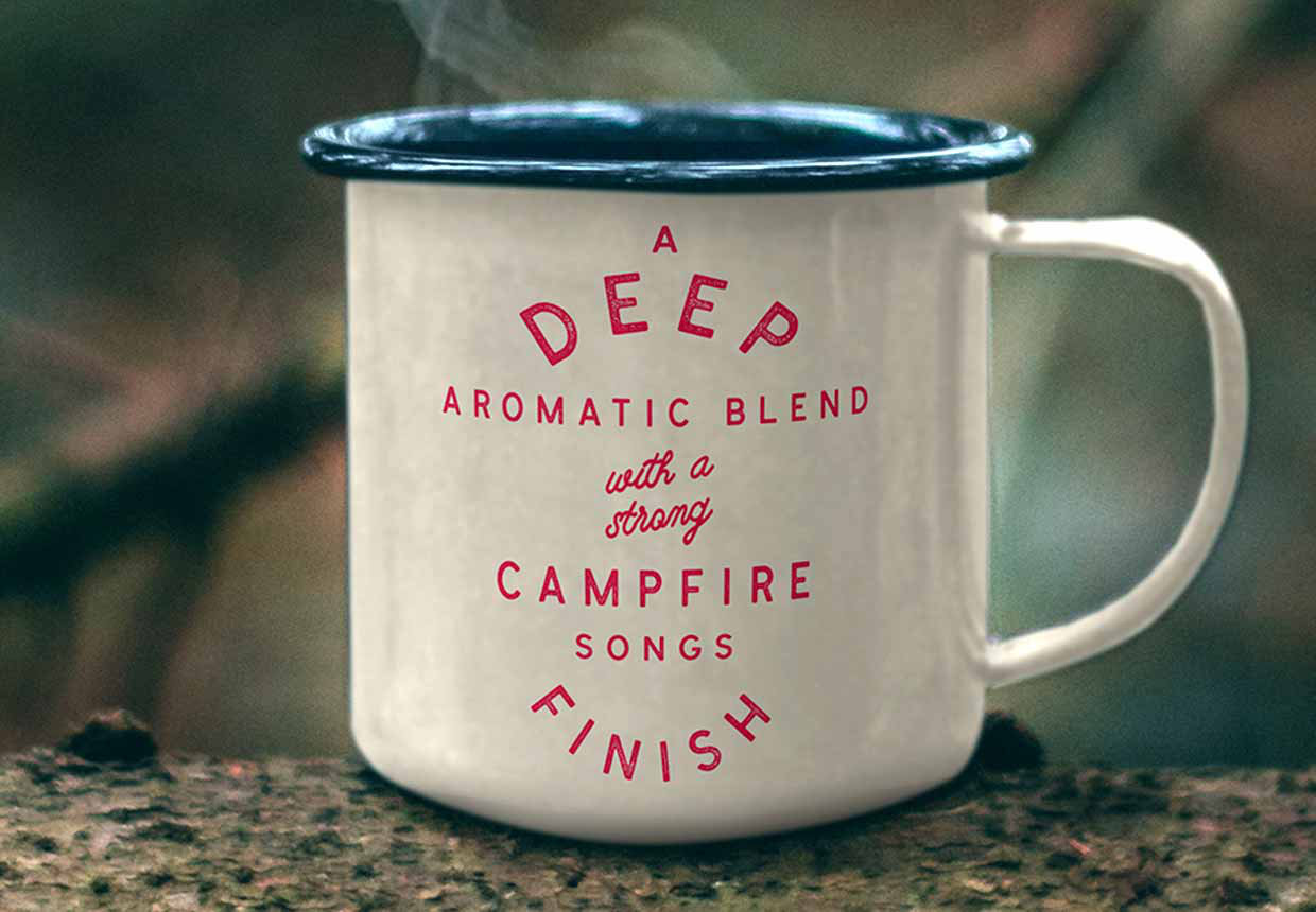 A tin coffee mug printed with the saying 