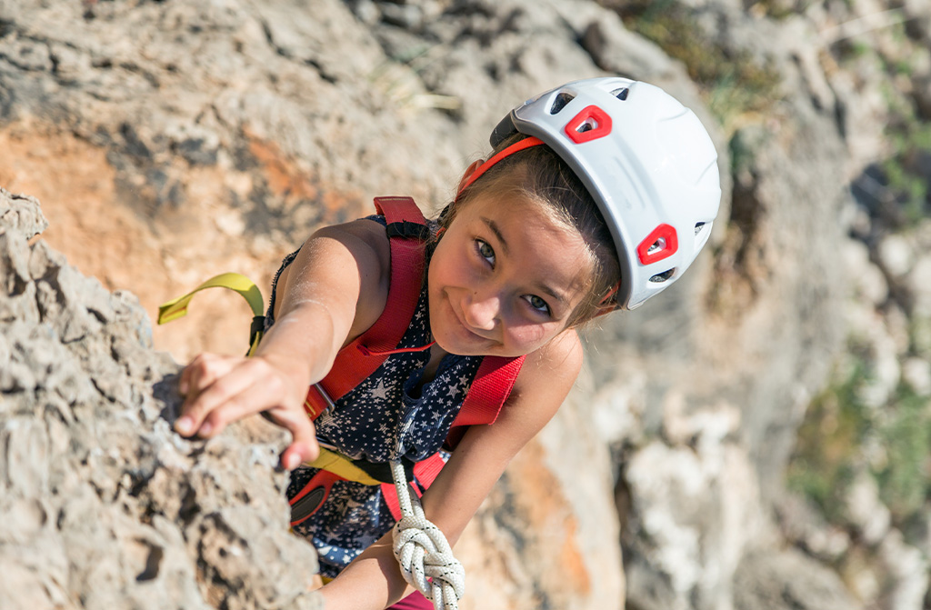 Girl climbing on a rock